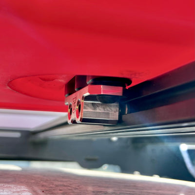 Billet aluminum Rotopax mount adapter for extrusion roof rack cross bars.