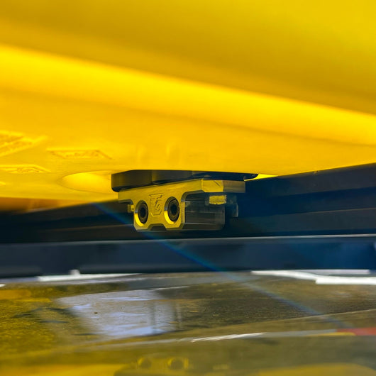 Billet aluminum Rotopax mount adapter for extrusion roof rack cross bars.