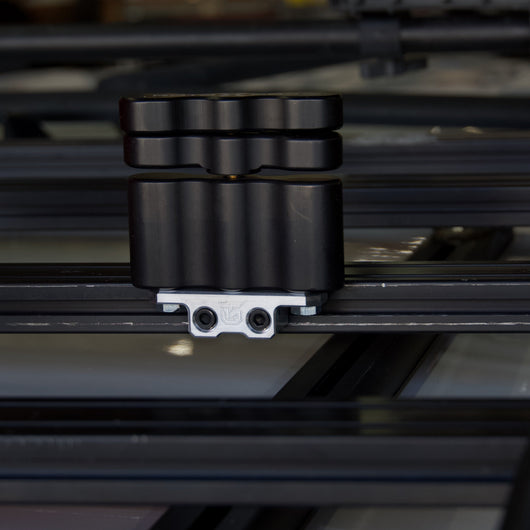 Billet aluminum Rotopax mount adapter for extrusion roof rack cross bars.