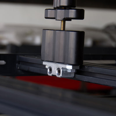 Billet aluminum Rotopax mount adapter for extrusion roof rack cross bars.