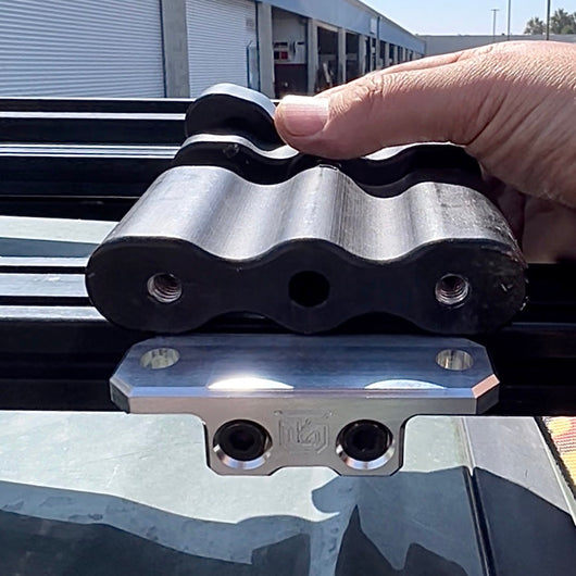 Billet aluminum Rotopax mount adapter for extrusion roof rack cross bars.